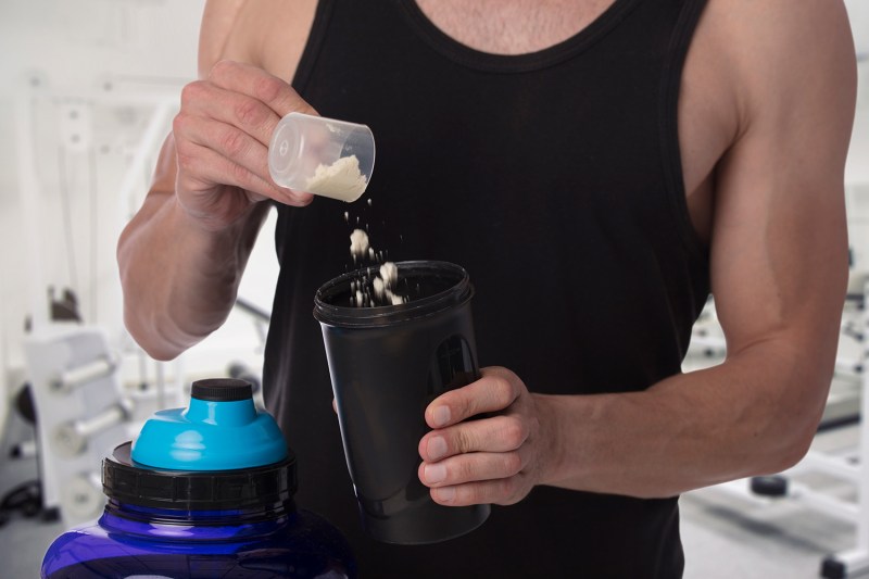 Man put whey protein in shaker.