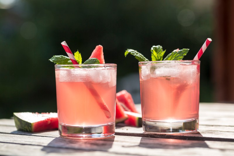 Two thirst-quenching glasses of watermelon cocktails on a wooden table.