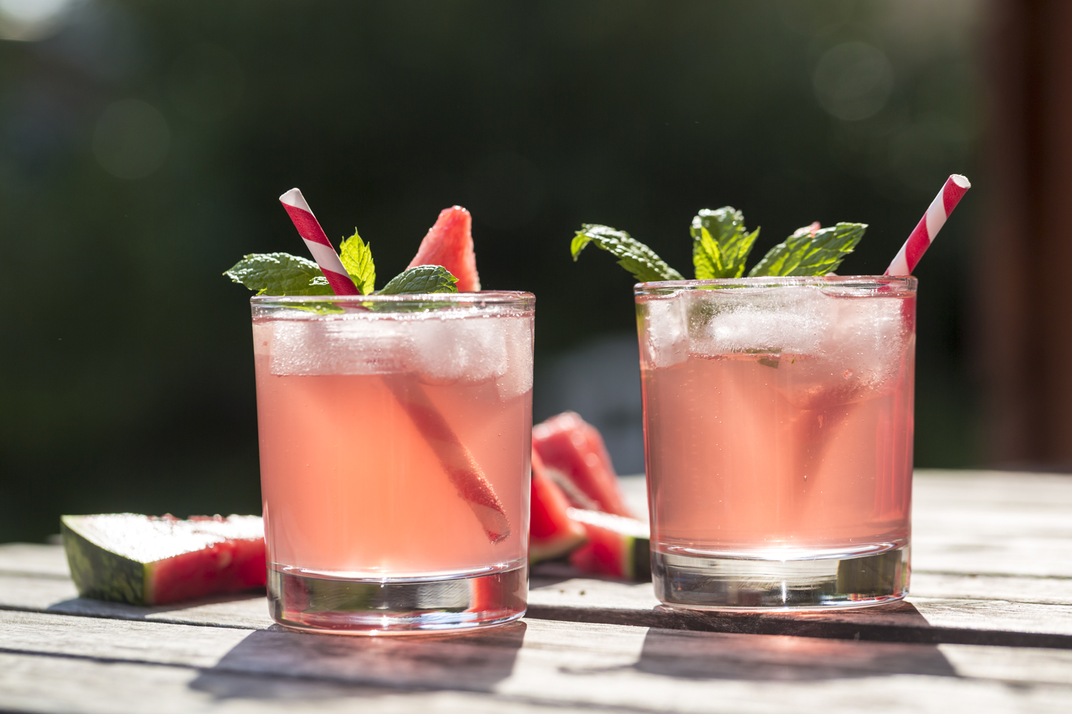 Two thirst-quenching glasses of watermelon cocktails on a wooden table.