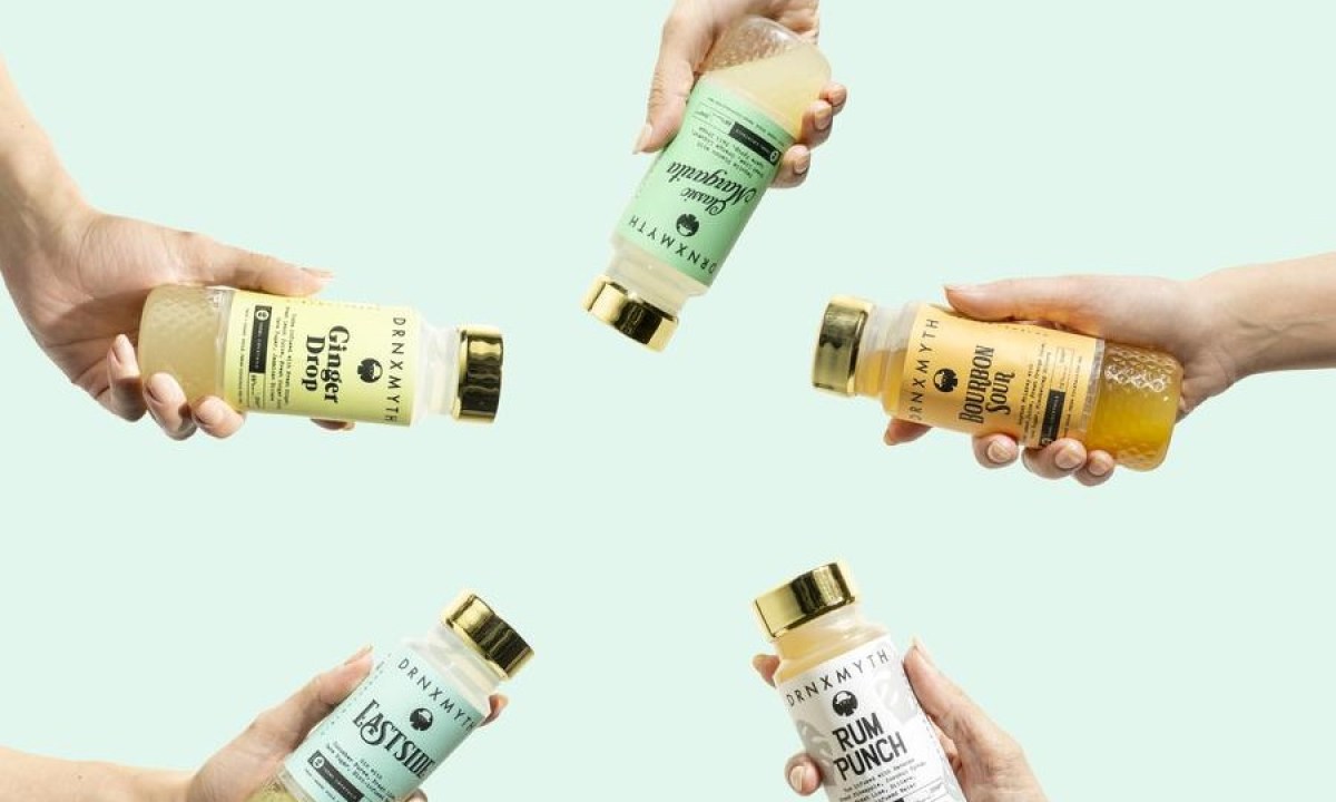 Five hands holding out different flavors of pre-made cocktails.