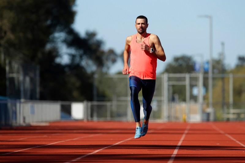 A male runner trains on a track on a sunny day in San Diego, California. San Diego is one of the top places for runners to train in the United States because of its low precipitation and mild climate.