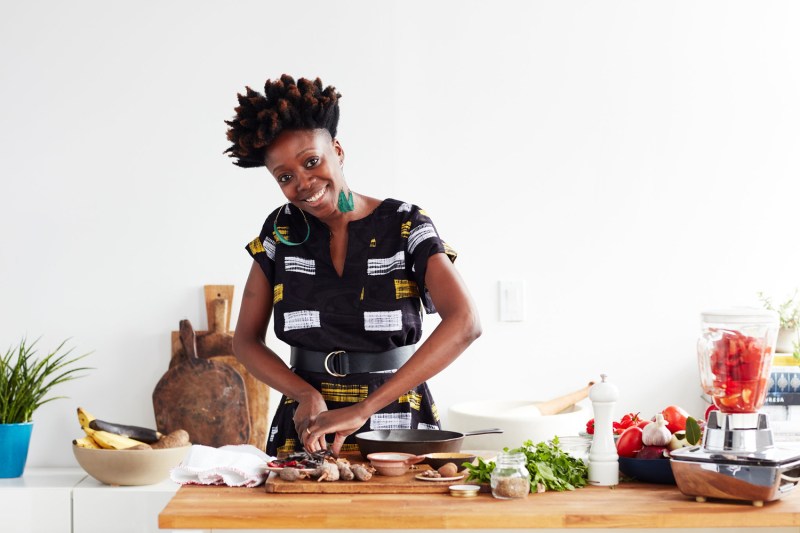 Yewande Komolafe of NYT Cooking happily prepares a dish.