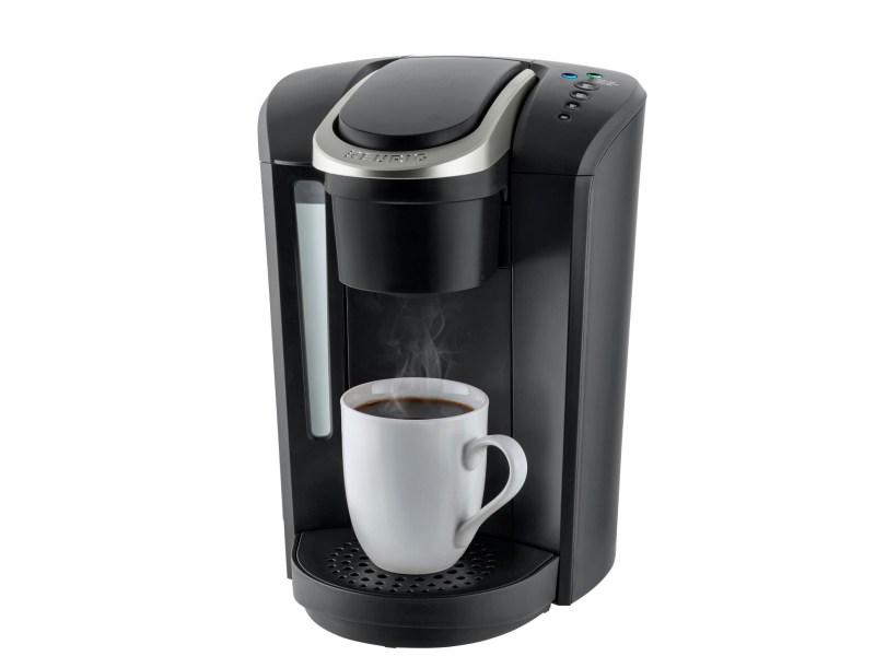 Keurig K-Select Single-Serve Maker with standard mug and brewed coffee.