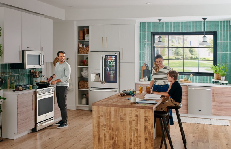 LG Studio Appliances in a kitchen with family members.