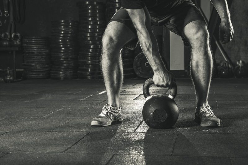 Kettlebell training in gym. Athlete doing workout