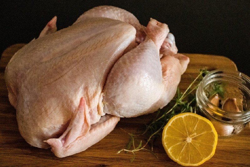 raw chicken on cutting board 