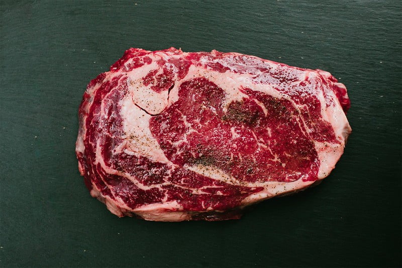 A raw ribeye steak.