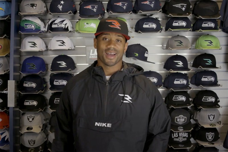 Russell Wilson wearing a hat from his new line with Lids.