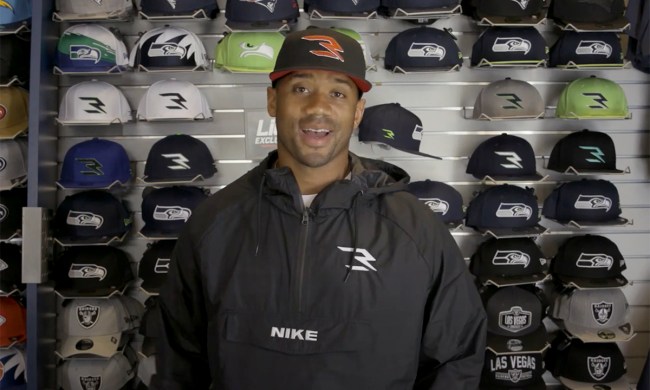 Russell Wilson wearing a hat from his new line with Lids.