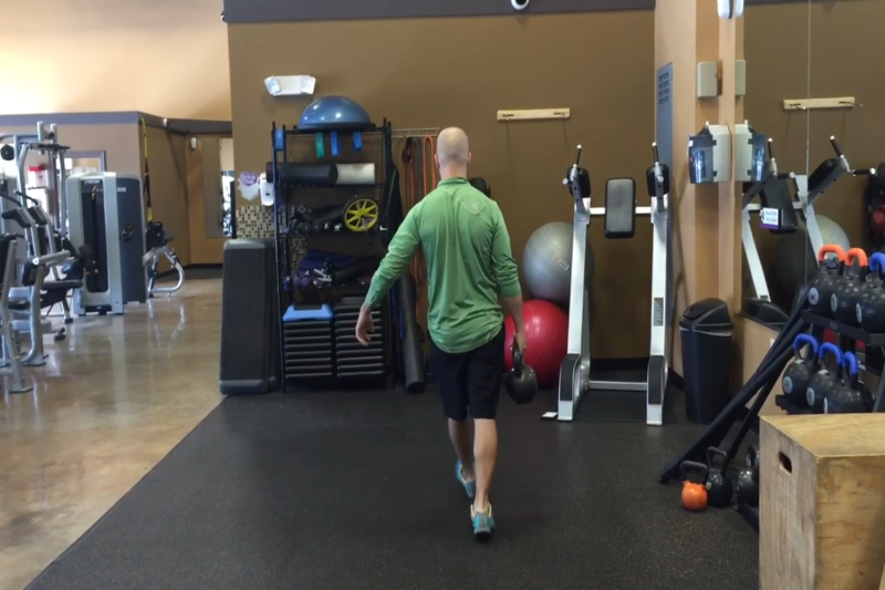 Luke Andrus performing the single-arm farmer’s carry.