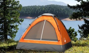 Wakeman 2 person dome tent in orange installed outdoors in mountains.