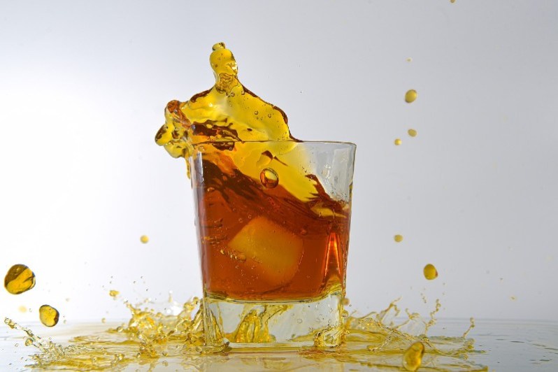 Whiskey spilling out of the glass.