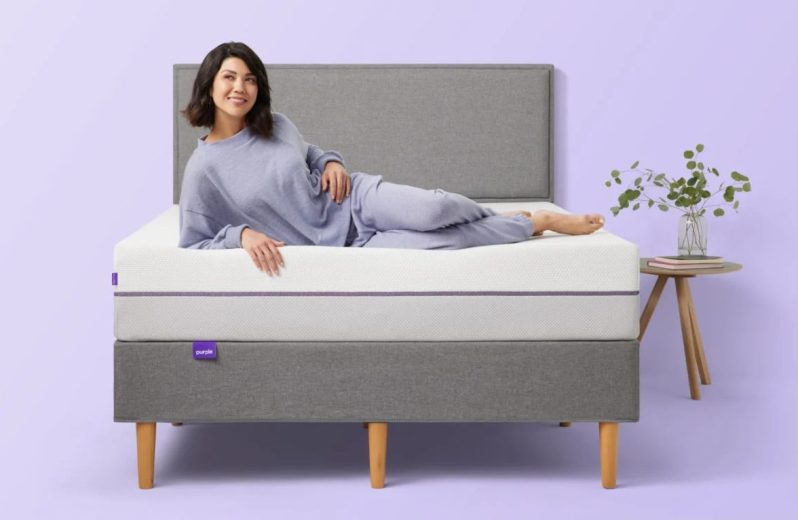 A smiling person on a Purple mattress.