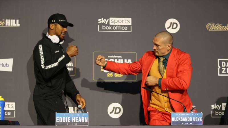 Anthony Joshua and Oleksandr Usyk presser with two opponents meeting face to face.