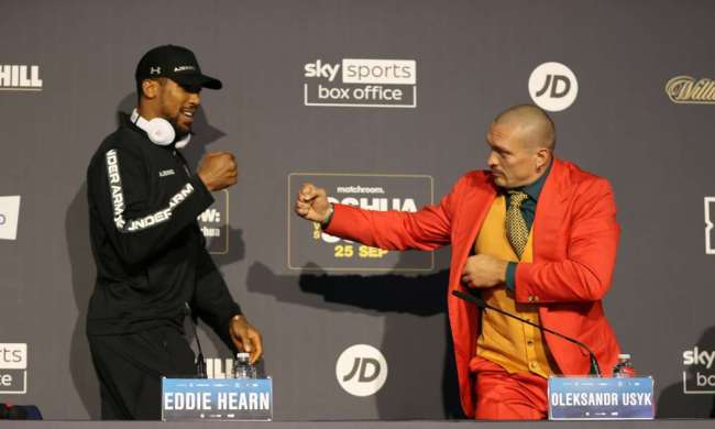 Anthony Joshua vs Oleksandr Usyk presser with two opponents meeting face to face.