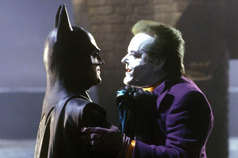 Batman lifting The Joker by the collar.