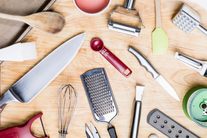 Assorted kitchen utensils on a wooden table.