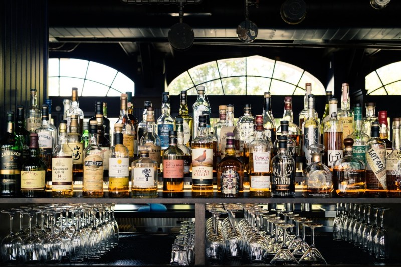 bottles of whiskey sitting on a shelf.