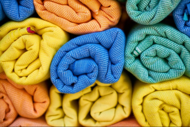 Colored towels rolled up and stored.