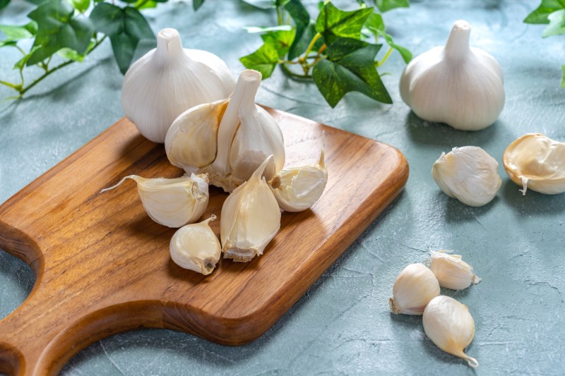 Garlic on wooden cutting board.