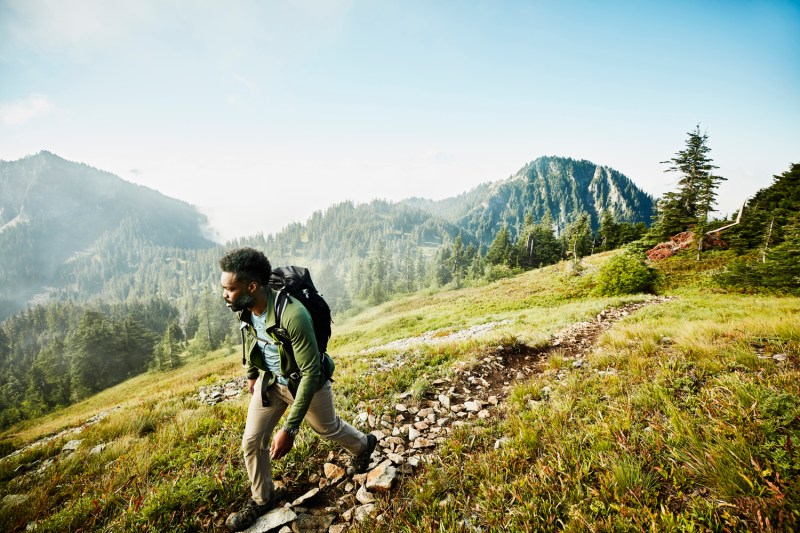 A man going on an early-morning hike in the mountain.
