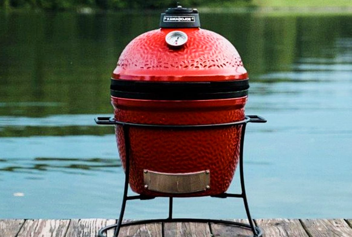 Kamado Joe Jr. 13.5 inch Charcoal Grill in Blaze Red on a dock.