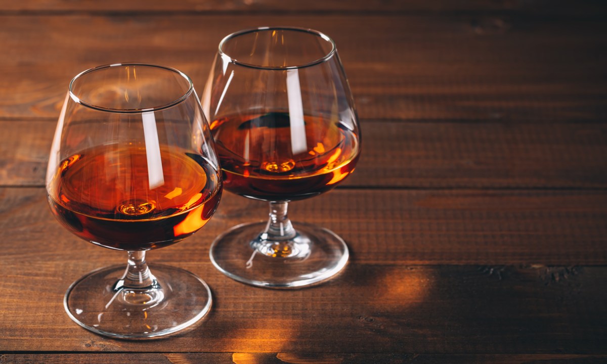 Two glasses of cognac on a wooden table