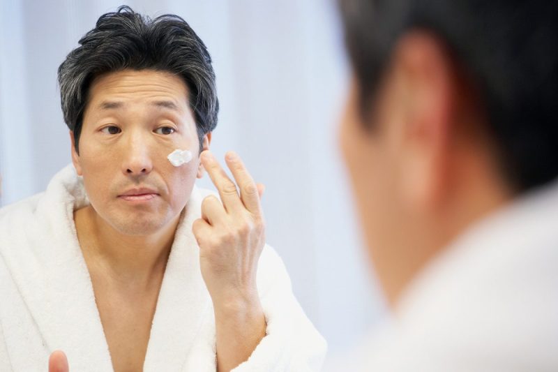 Man applying face cream.