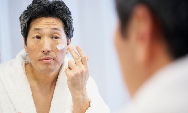 Man applying face cream.