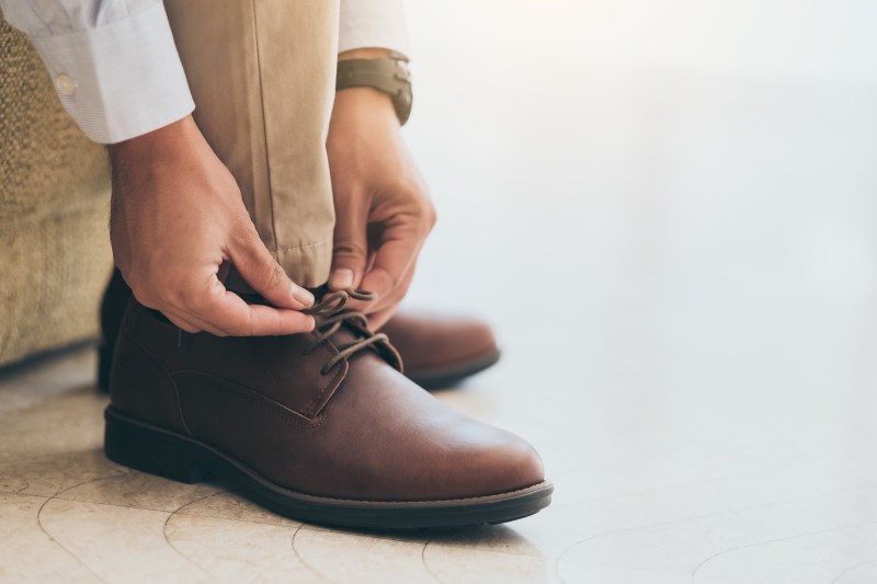 Man tying his one of his boots.