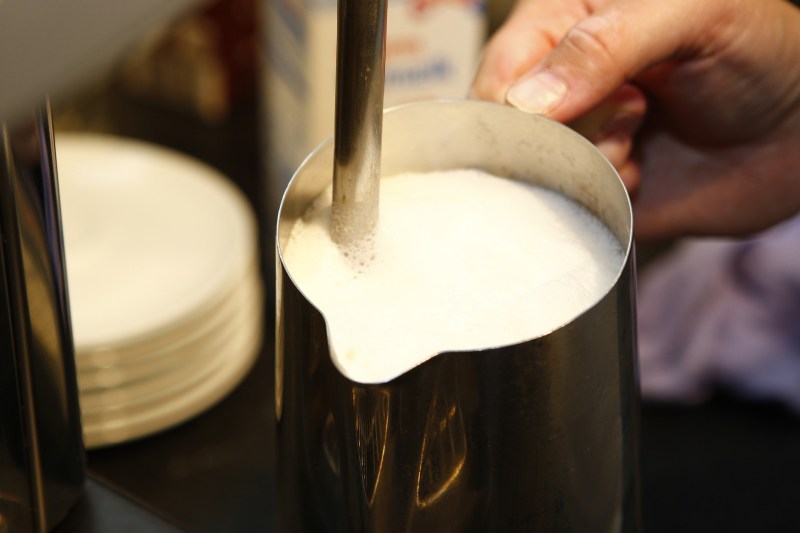 Milk is steamed using an espresso machine.