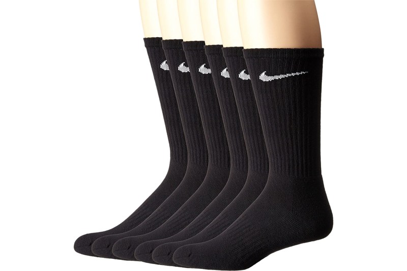 A close-up of feet wearing Nike crew socks.