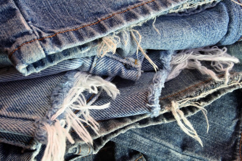 A pile of ripped denim jeans.