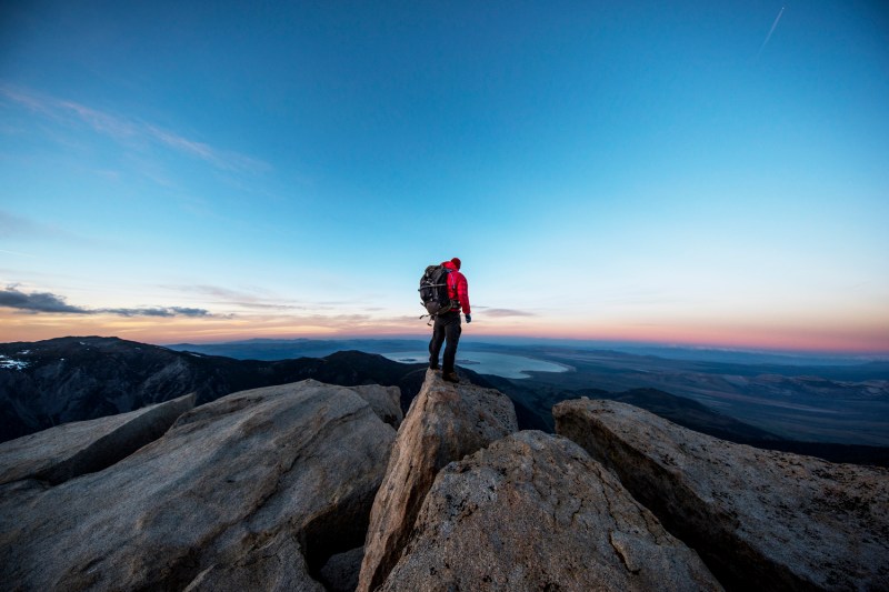A male hiker standing on the summit