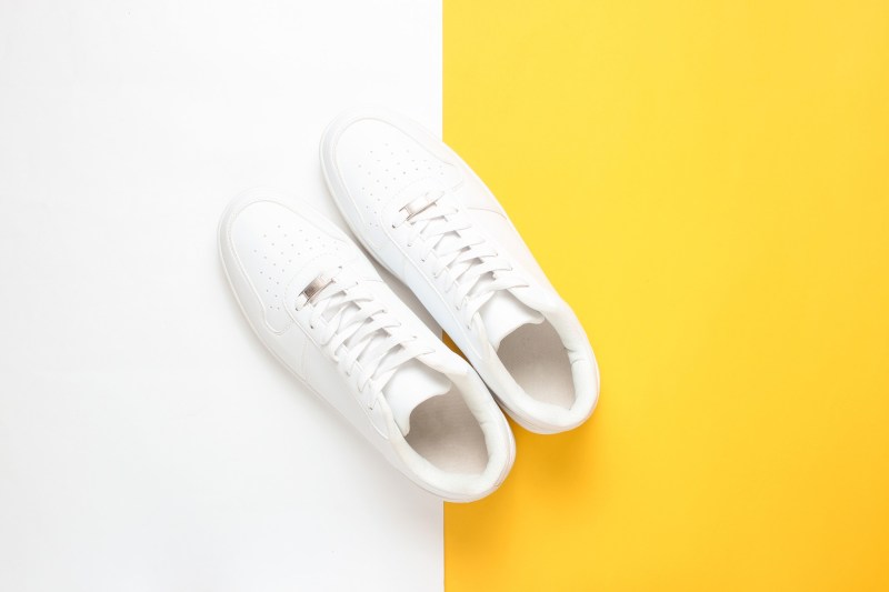 White sneakers on a white and yellow background.