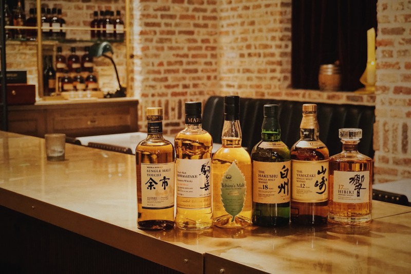 Array of Japanese whisky bottles on a counter.