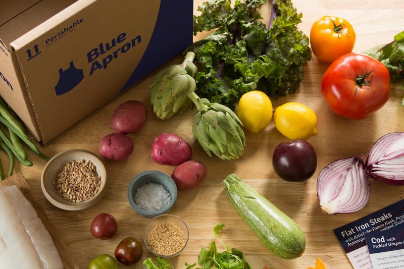 Blue Apron box next to food on table.