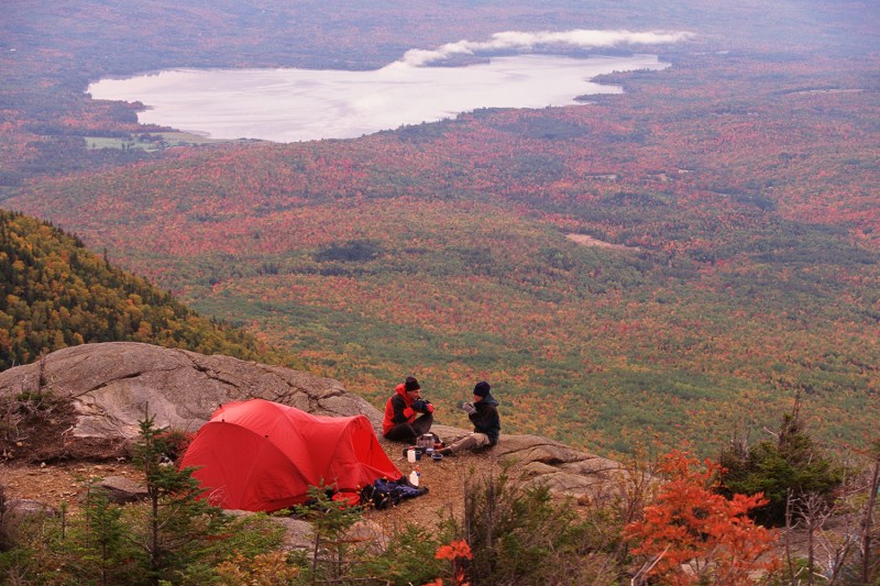 Couple sitting in campsite in fall