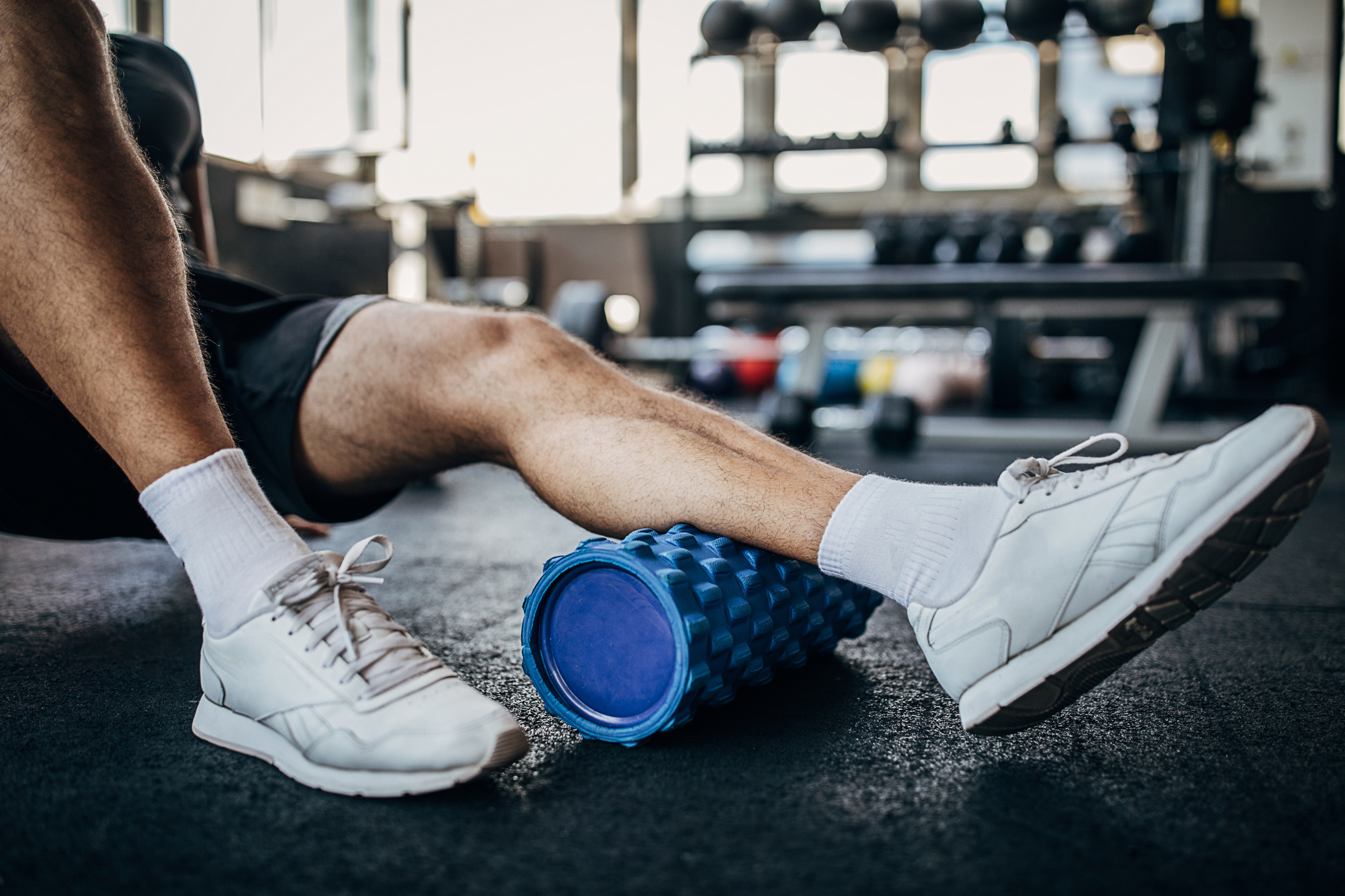Man using foam roller.