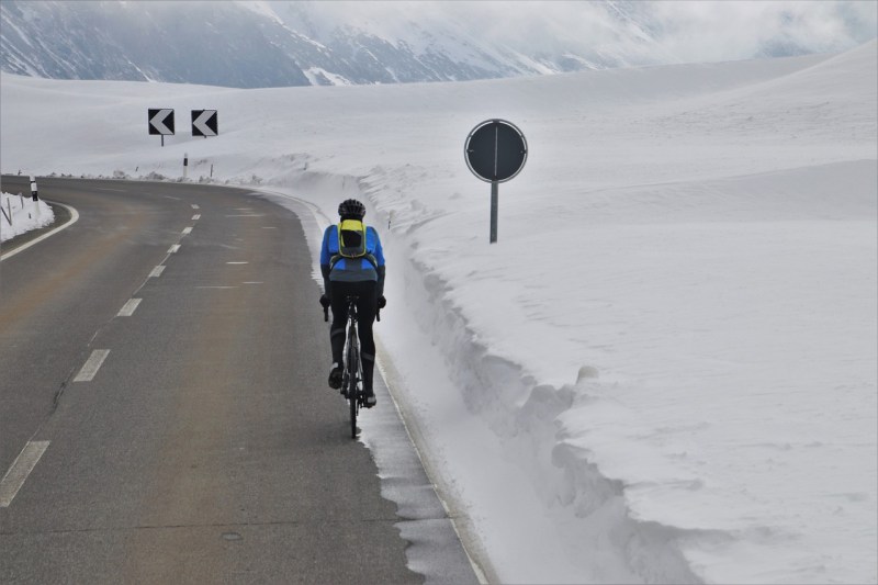 Man cycling in snowy conditions.