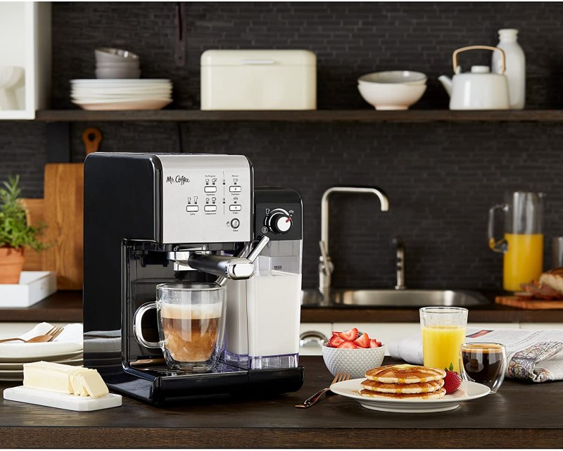 Mr Coffee one touch espresso maker in a kitchen setting with breakfast dishes.