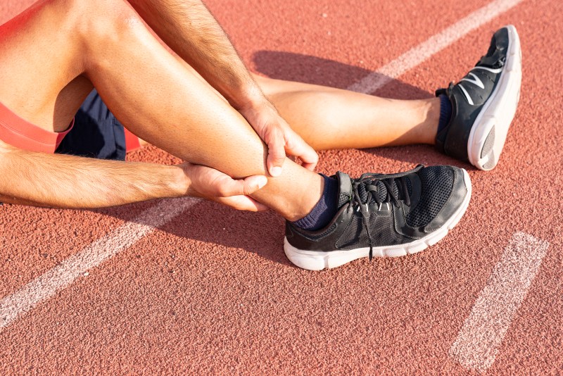 Sport injury, A man has ankle pain during outdoor exercise. knee Injuries.