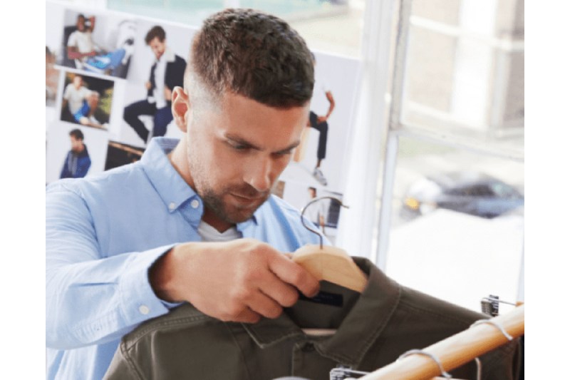 Man choosing clothing in store.