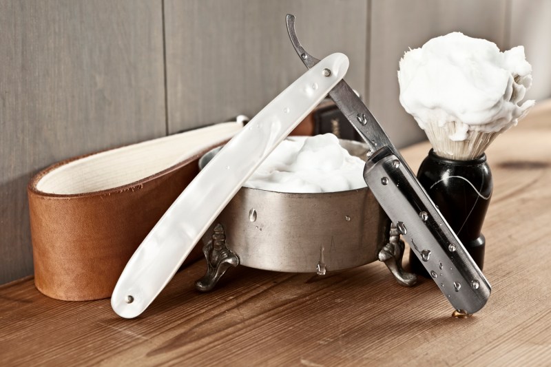 A strop and other shaving essentials on a table.
