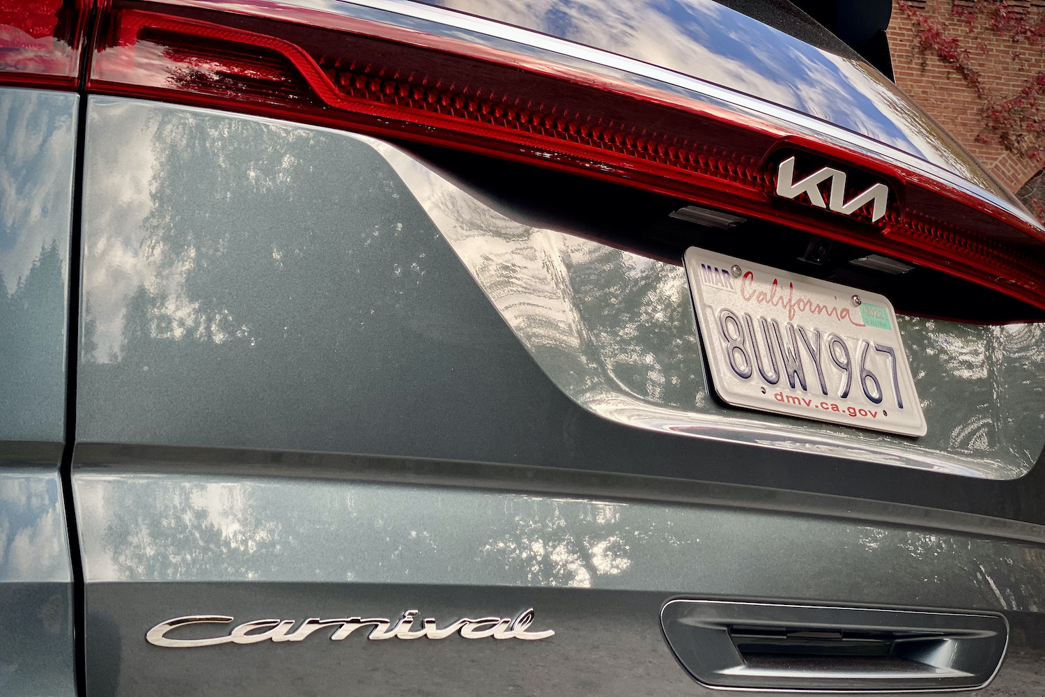 Kia Carnival close up of Carnival badge and rear taillight.