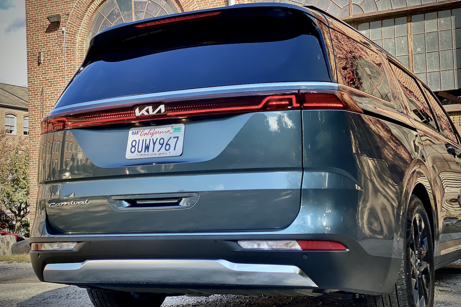 Kia Carnival rear end close up with daytime running lights on.