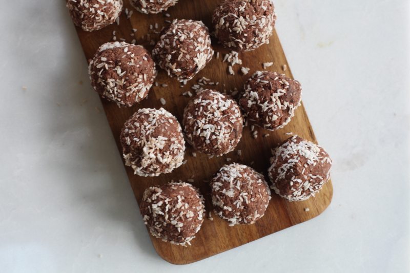 homemade protein balls on a cutting board.