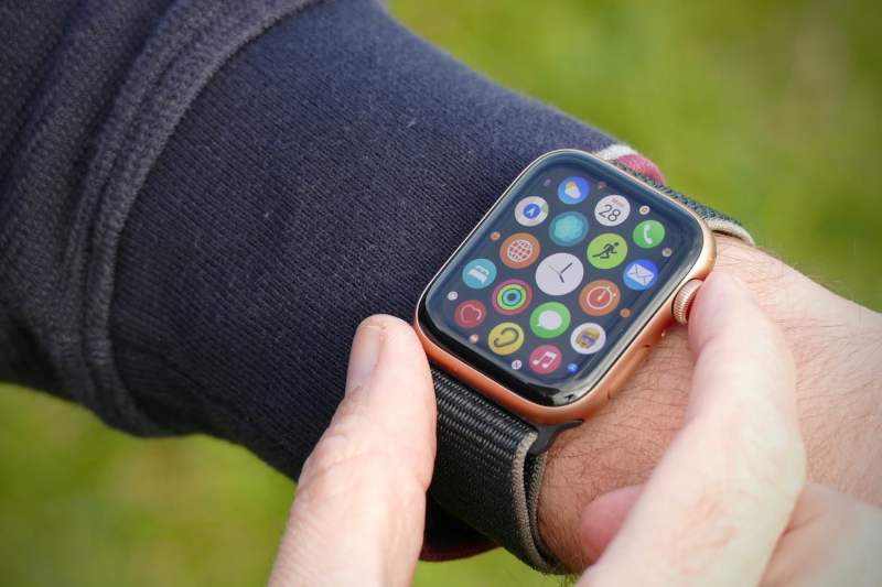 An Apple Watch SE being worn on someone's wrist with the apps displayed on its screen.