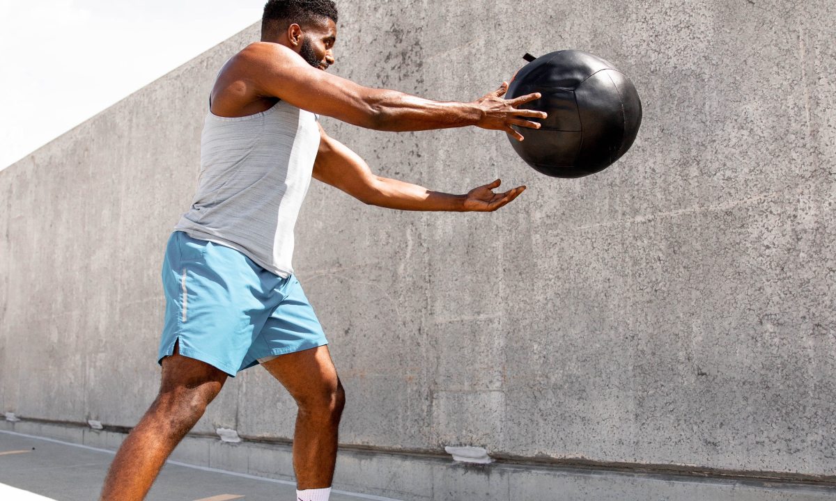 Man exercising with medicine ball.