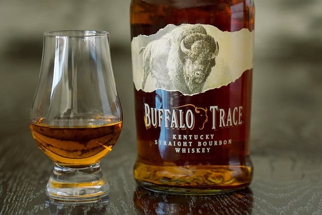 A glass and a bottle of Buffalo Trace.